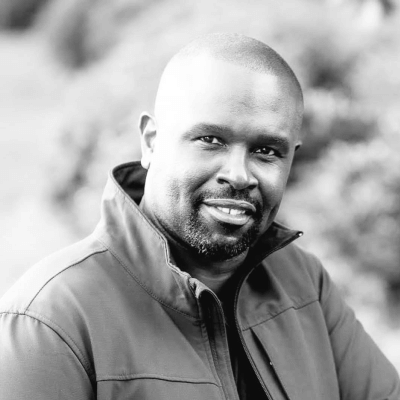 Photo of Chris Kiadii, Director of The Real Estate CRM School, for whom Zoho Writer automations and workflows have eliminated manual work